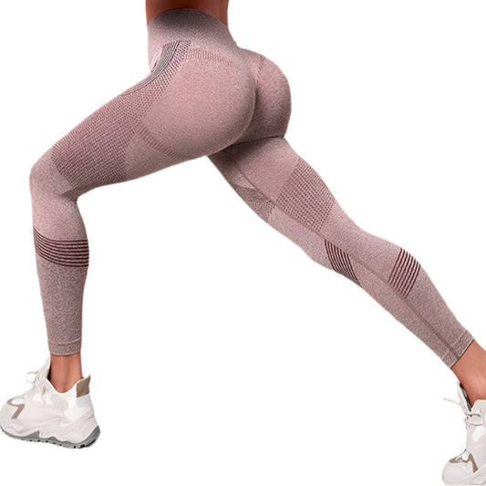Person wearing pink leggings and white sneakers on a white background